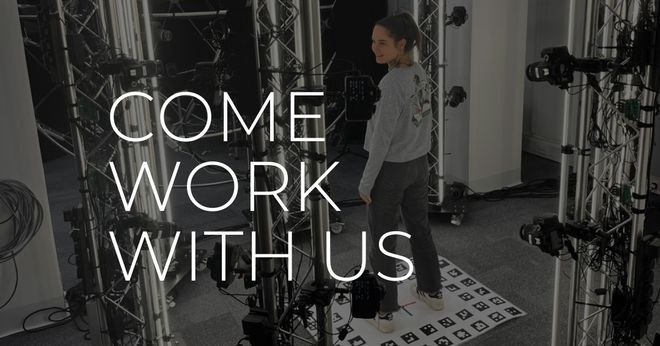 A person stands in a professional film studio filled with camera rigs, cables, and lighting equipment; large white text overlay reads "COME WORK WITH US."